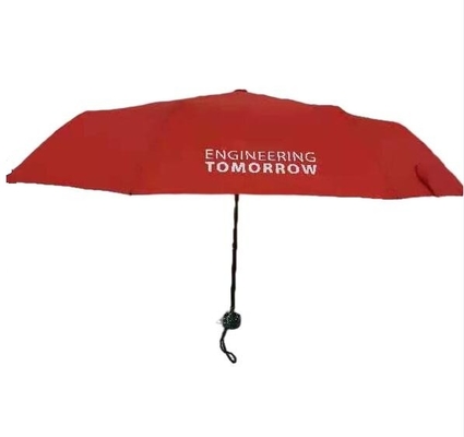 Handbuch offen über dem Druck von roten Falten des Regenschirm-3